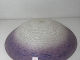 a purple and white bowl sitting on a white surface