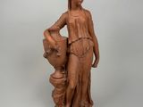 an image of a statue of a woman holding a vase