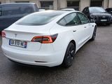 a white tesla model s parked in a parking lot