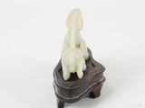 a figurine of a dog sitting on top of a box