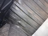 a close up of a car seat with a dirty seat belt