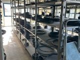 many pots and pans on the shelves in the kitchen