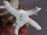 a hand holding a white ceramic object with a star on it