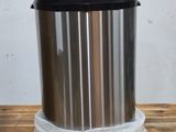 a trash can sitting on top of a wooden table