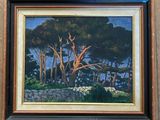 painting of trees in a wood frame hanging on a wall