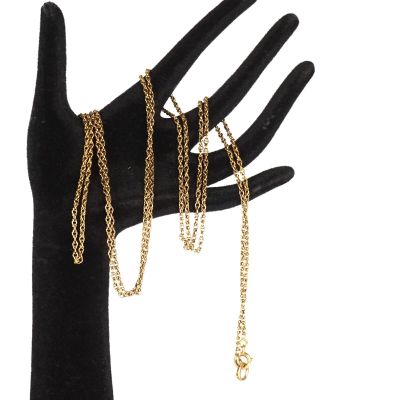 un gros plan sur la main d'une personne tenant un bracelet à chaîne en or