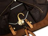 the back of a brown and black backpack with a brown handle