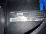 a close up of a black laptop with a blue cable