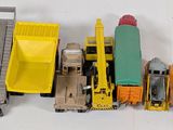 a lot of toy trains and trucks on a white surface