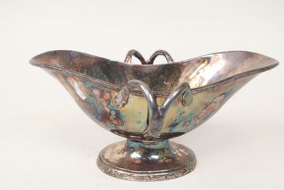 a silver bowl with a butterfly decoration on it
