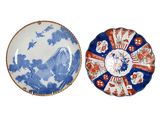 two blue and white plates with designs on them on a white surface