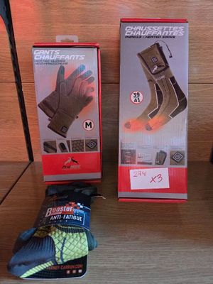 two boxes of gloves and a pair of gloves on a table