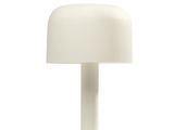 a white table lamp with a white shade on top of it