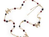 a close up of a necklace on a white surface