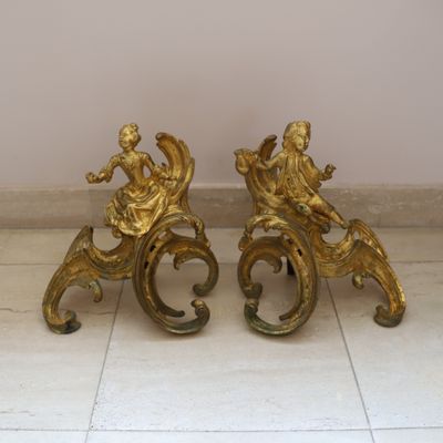 two statues sitting on top of each other on a tile floor