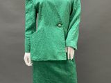 a mannequin wearing a green dress and jacket on a mannequin mannequin mannequin mannequin mannequin mannequin manne