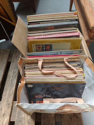 a lot of records in a bag on a table