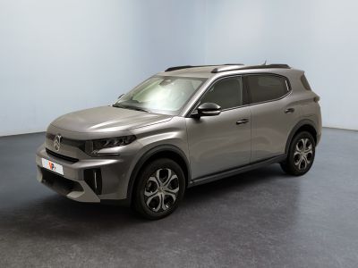 the silver suv is parked in a room with a black floor