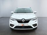 the front view of a white car in a white room