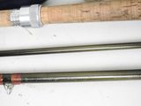 two different types of fishing rods on a table