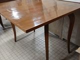 an image of a table in a room with a painting on the wall