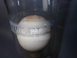 a glass with a ball inside of it on a table