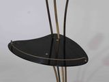 a black and gold table with a flower on it