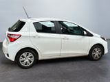 the back of a white toyota yaris parked in a room
