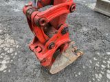 a red machine that is sitting on the ground