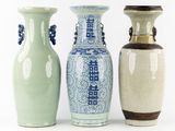 three vases are sitting side by side on a white surface