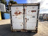 a white container with rust on it in a parking lot