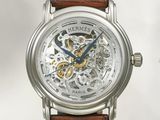 the watch is made of stainless steel and leather with a brown strap