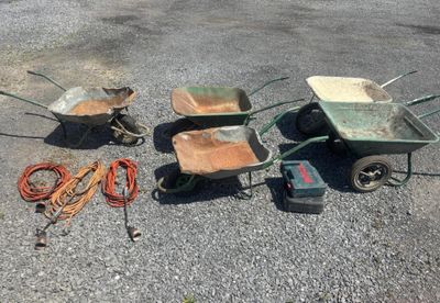 three wheelbarrows, a wheelbarrow, a wheelbarrow, and a wheelbarrow on the ground