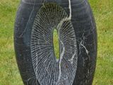 a black stone sculpture with a hole in the middle of it