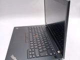 a laptop with a black keyboard sitting on a white surface