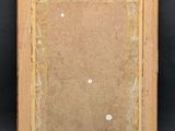 an old picture frame with a small hole in the middle of it