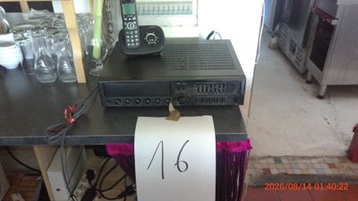 a picture of a table with a phone and a sign on it