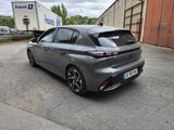 the rear end of a grey toyota mira parked in a parking lot