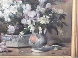 a painting of flowers in a vase on a table