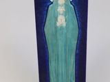a statue of the virgin mary of guadalupe on a wooden base