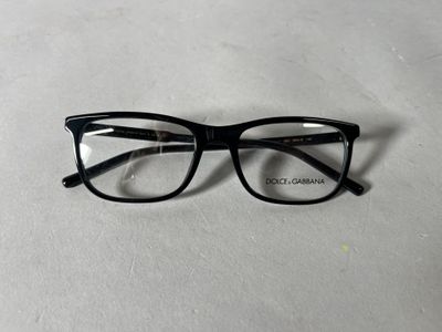 a close up of a pair of glasses on a white surface
