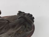 a statue of a man with a snake on his back