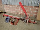 a picture of a red crane sitting in front of a brick wall