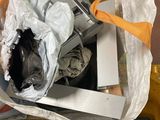 a pile of electronic equipment in a bag on the floor
