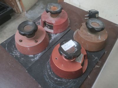 three red and black stove top burners sitting on a table