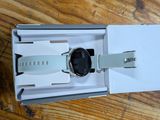 a box with a watch inside of it on a wooden table