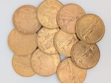 une pile de pièces d'or posée sur une surface blanche