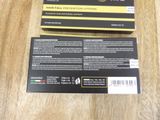 the box is open on a wooden table with a black and yellow label