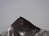 a silver spoon with a cross on it on a table