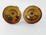 pair of antique brass candlesticks on a white background